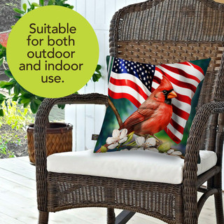 American Cardinal Indoor/Outdoor Pillow on wicker chair with white cushion and US flag design.