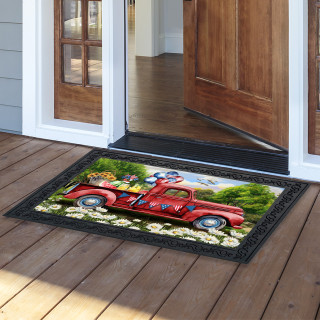 American Pickup Picnic Doormat with red vintage truck design on black background with white flowers.
