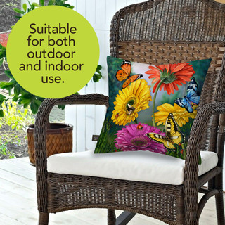 Butterflies and Daisies colorful floral pillow on wicker chair, vibrant flowers and butterflies design.