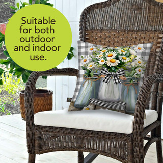 Farmhouse Jars Indoor Outdoor Pillow on wicker chair with white cushion and floral decorative pillow.