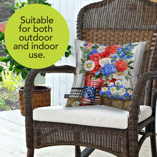 Red White and Beautiful floral indoor/outdoor pillow on a wicker chair with white cushion and seat.