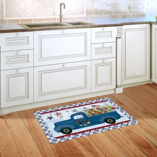 Blue truck doormat on wooden floor in front of white kitchen sink and cabinets.