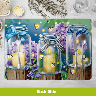 Dragonfly Garden Placemat with purple flowers, candles in jars, and utensils on a wooden surface.