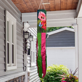 Garden Gerber Daisies Windsock Wind Twister with pink flowers and green stripes hanging from porch.