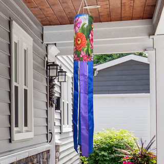 Zinnia in Bloom Windsock Wind Twister, colorful floral windsock with purple and blue tails hanging outdoors.