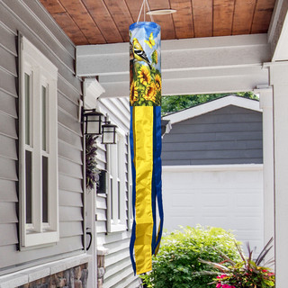 Goldfinches and Sunflowers windsock wind twister hanging from a porch ceiling with blue and yellow design.