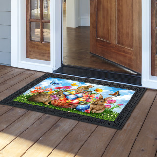 Springtime Bunnies Doormat with colorful Easter eggs and bunnies on a black background with green grass.