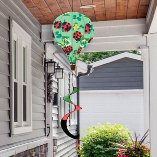 Ladybug Deluxe Hot Air Balloon Spinner, green hot air balloon with ladybugs and leaves outdoors.