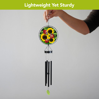 Ladybugs and Sunflowers Illuminated Wind Chime with black tubes and green leaf, held by hand.