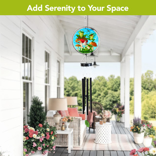 Happy Frogs Illuminated Wind Chime with colorful frogs and flowers, hanging on a porch.
