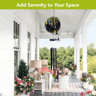 Black Bear Family Illuminated Wind Chime hanging on a porch with colorful lights shining.