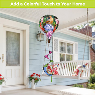 Perched Cardinals hot air balloon spinner with colorful flowers and birds on a porch swing outdoors.