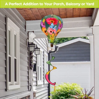 Garden Gerber Daisies hot air balloon spinner with colorful flowers and rainbow tail outdoors on porch.