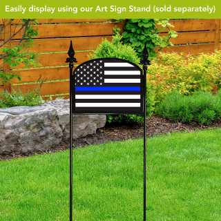 Black Honor Protect Serve Acrylic Art Sign with blue line, stars, and stripes on stand outdoors.