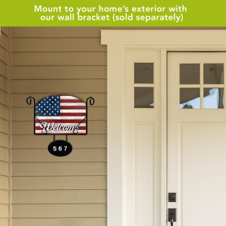 Wooden American Flag Acrylic Art Sign mounted on beige siding next to a white door.