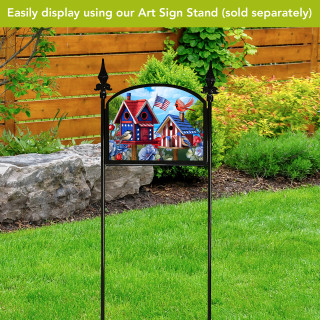 Home of the Free Birdhouses colorful acrylic art sign on a decorative black garden sign stand.