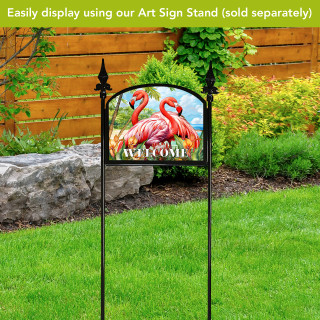 Flamingo pair acrylic art sign on stand with welcome text on a garden lawn display.