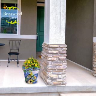 Briarwood Lane Goldfinches and Hydrangea medium planter with yellow flowers on a home's front porch.