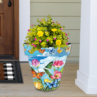 Large Sunshine Butterflies planter with colorful butterfly, flower, and cloud design filled with green and blooms.