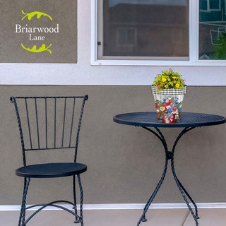 Briarwood Lane small black metal table and chair with yellow flowers in a decorative basket.