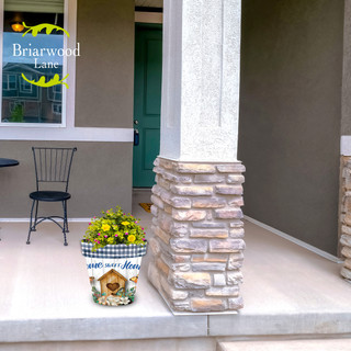 Country Home Sweet Home Medium Planter with yellow flowers on a front porch beside a pillar.