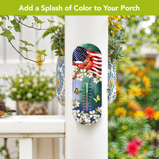 American Cardinal Metal Thermometer with floral and American flag design on a porch post outdoors.
