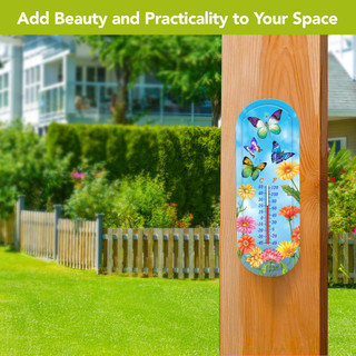Fluttering Butterflies Metal Thermometer with colorful flowers and butterflies on a wooden post outdoors.