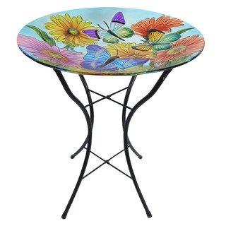 Round glass birdbath table with colorful butterfly and flower design on black metal stand base.
