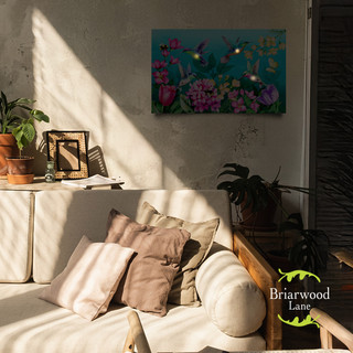 Springtime Hummingbirds Large LED Canvas Art on a wall above a cream couch with pillows.