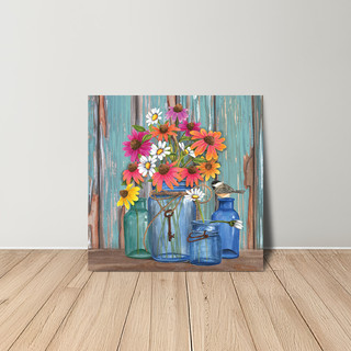 Vibrant flowers in colorful glass jars on a wooden shelf against a rustic blue background canvas art.