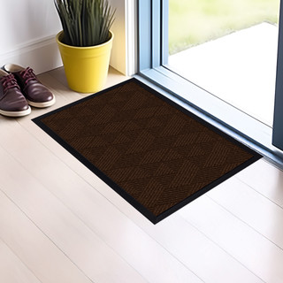 Brown geometric large flocked doormat with black border on white wooden floor by glass door entrance.