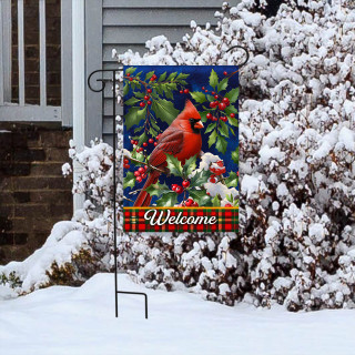 Cardinal and Holly garden flag with red bird, green leaves, and "Welcome" on snowy display stand.