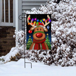 Festive Reindeer Garden Flag with colorful lights and scarf displayed on a stand in snowy yard.
