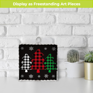 Black metal mini Christmas ornament with red, green and white checkered trees and snowflakes design.