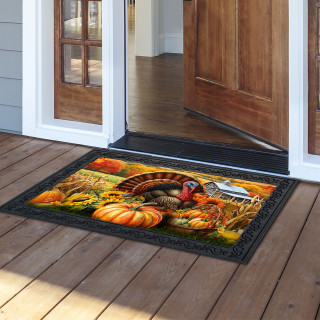 Wild Turkey and Pumpkins doormat with black border on a wooden porch outside an open door.
