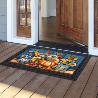Fall Feathered Friends Doormat with colorful birdhouse, pumpkins, and sunflowers design on wooden porch.