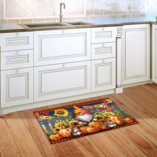 Gnome and Pumpkins doormat on wooden floor in front of white kitchen cabinets and sink area.
