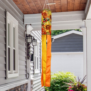 Welcome Fall Flowers Wind Spinner hanging from a porch with vibrant orange and yellow floral design.
