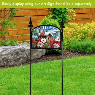 Cardinals and Poinsettias Acrylic Art Sign on stand with garden background, featuring red birds and flowers.