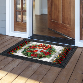 Cardinal Wreath Doormat with red cardinal, green leaves, and plaid border on wooden porch floor.