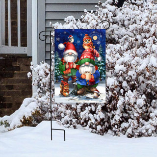 Warm Wishes Gnomes Garden Flag with colorful gnomes and snowy scene on metal stand outdoors.