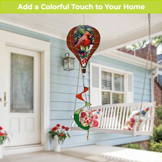 Cardinal and Holly Hot Air Balloon Spinner with red bird, flowers, and plaid pattern hanging outdoors.