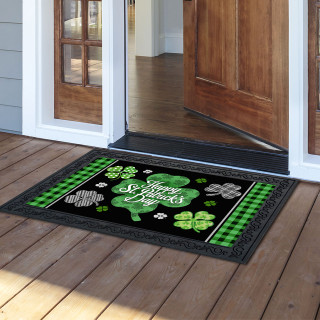 Black doormat with green shamrocks, shamrock design, and "Happy St. Patrick's Day" text on wooden porch.