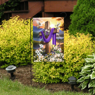 Easter Sunrise Cross Garden Flag with purple cloth and white flowers on a garden stand outdoors.