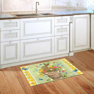 Flowerpot Bunny Doormat on wooden kitchen floor beside white cabinets and sink with colorful floral design.