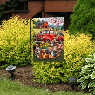 Farm Pups Garden Flag with colorful dog, truck, and floral design on a garden stand outside.