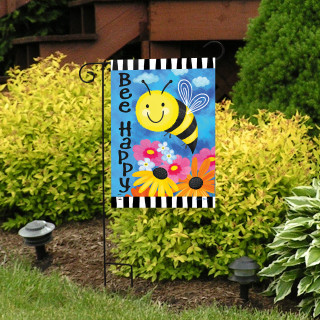 Bee Happy Bumblebee Garden Flag with colorful flowers and smiling bee on striped background outdoors.