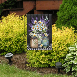 Lavender and daisies checkered garden flag with floral design on black and white background displayed outdoors.
