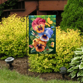 Pansy Trio Garden Flag with colorful pansies and butterfly design on a garden stand outdoors.