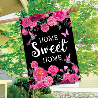 Black garden flag with pink roses, hummingbirds, and "Home Sweet Home" text on a wooden pole.
